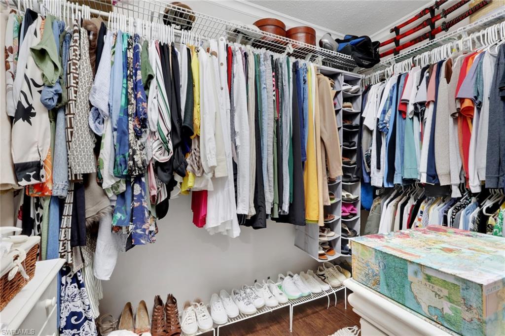 4983 18th Court Southwest Naples, FL 34116 - Photo 17 of 37 a view of walk in closet with clothes and shoes