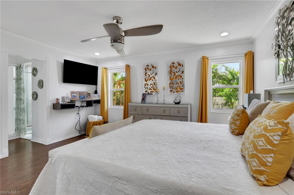 4983 18th Court Southwest Naples, FL 34116 - Photo 18 of 37 a bedroom with a large bed and a flat tv screen