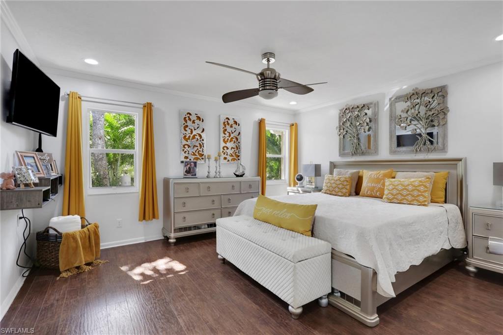 4983 18th Court Southwest Naples, FL 34116 - Photo 19 of 37 a bedroom with a bed furniture and a flat tv screen