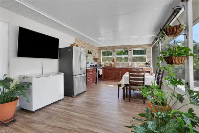a kitchen with a table chairs stove and refrigerator