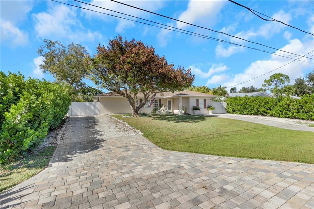 4983 18th Court Southwest Naples, FL 34116 - Photo 2 of 37 a view of a yard with a fountain