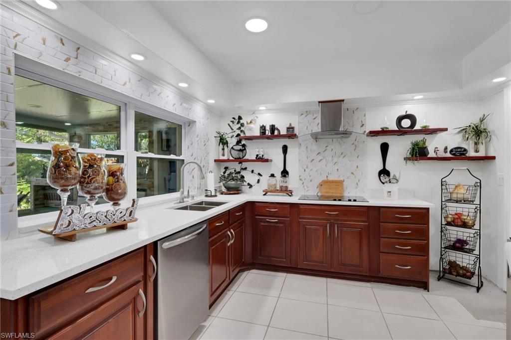4983 18th Court Southwest Naples, FL 34116 - Photo 24 of 37 a kitchen with a sink and cabinets