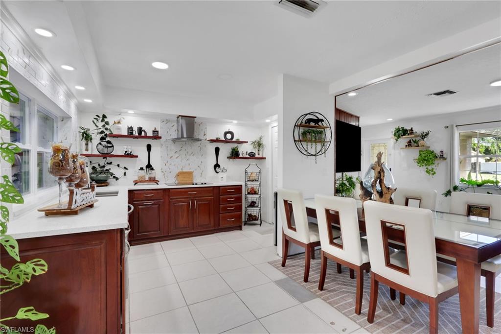 4983 18th Court Southwest Naples, FL 34116 - Photo 25 of 37 a large kitchen with a table and chairs