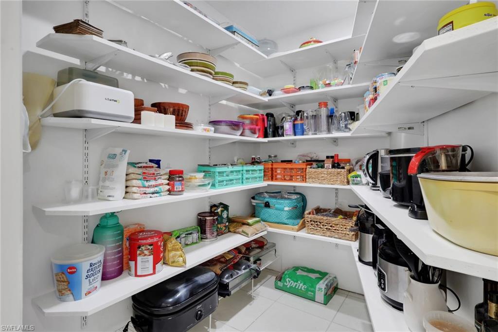 4983 18th Court Southwest Naples, FL 34116 - Photo 26 of 37 a storage room with lots of clutter and refrigerator