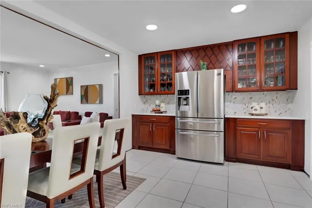 a dining room with furniture and a flat screen tv