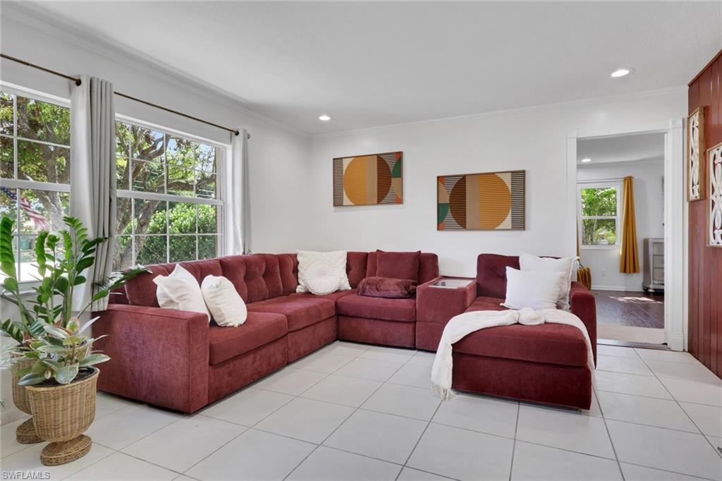 4983 18th Court Southwest Naples, FL 34116 - Photo 30 of 37 a living room with furniture and a potted plant