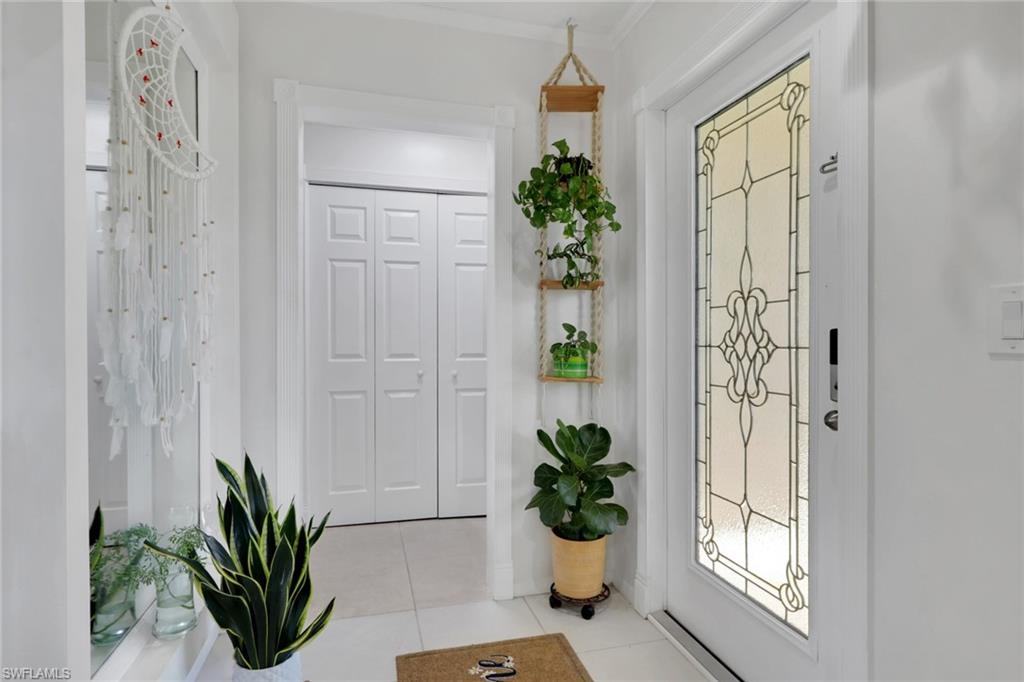 4983 18th Court Southwest Naples, FL 34116 - Photo 32 of 37 a view of a hallway to a house with wooden floor