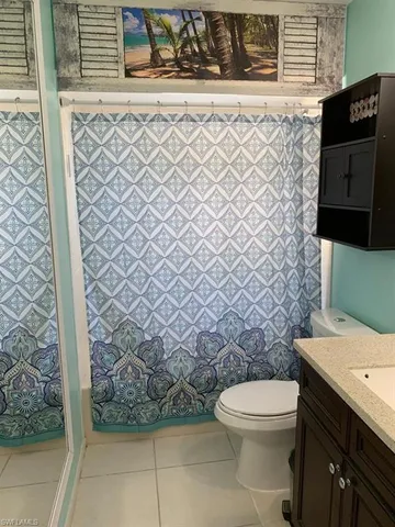 a view of a storage & utility room with a fridge