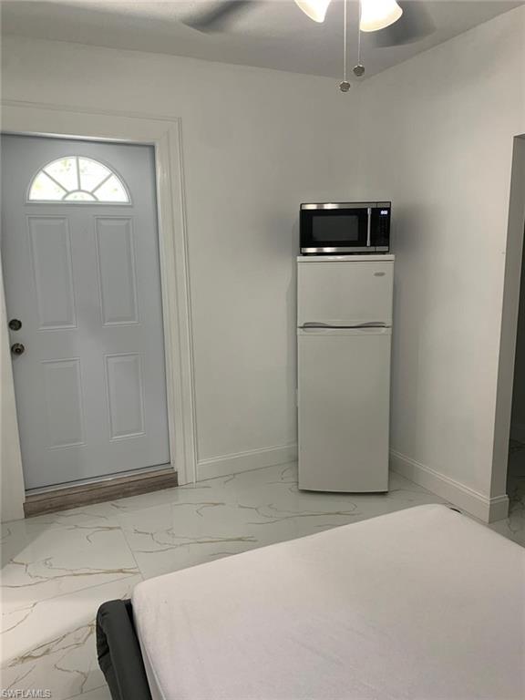 4983 18th Court Southwest Naples, FL 34116 - Photo 36 of 37 a view of a storage & utility room with a fridge