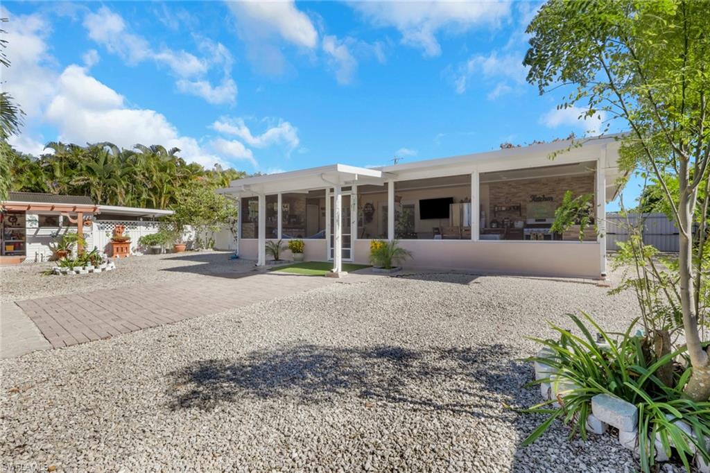 4983 18th Court Southwest Naples, FL 34116 - Photo 5 of 37 a view of a house with backyard and porch