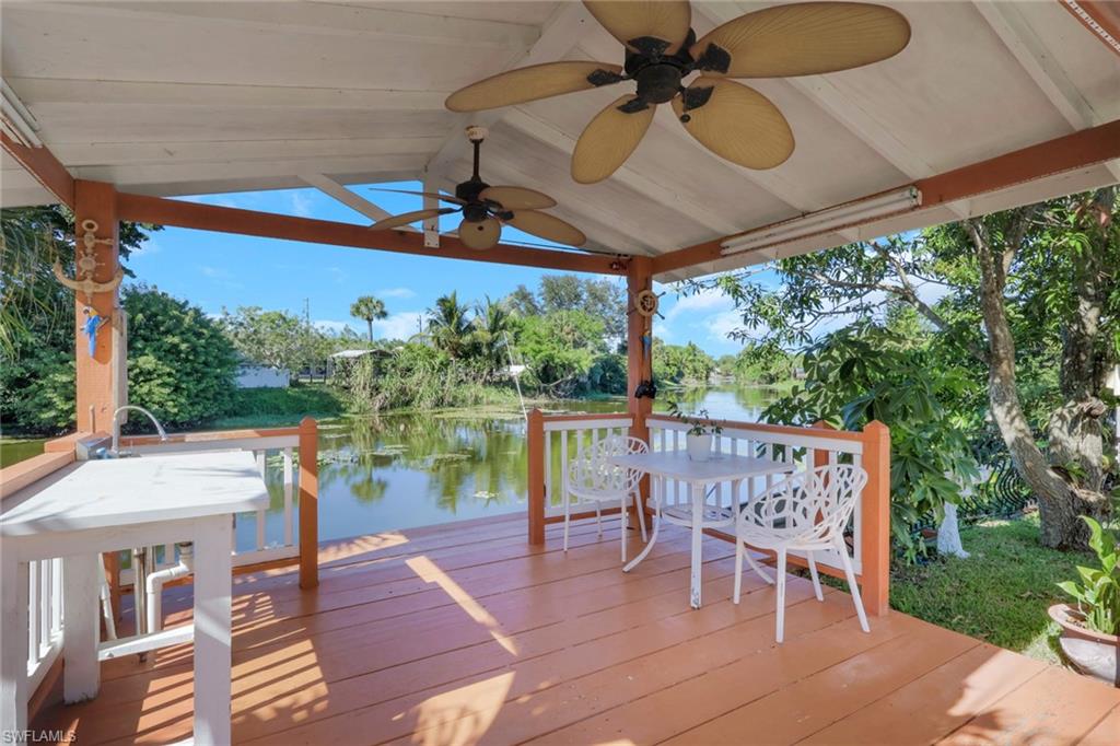 4983 18th Court Southwest Naples, FL 34116 - Photo 10 of 37 a view of a patio with a table chairs and a yard