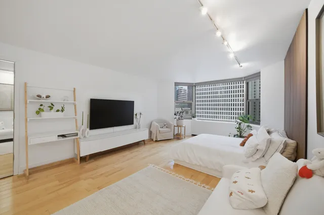 a bedroom with furniture and a flat screen tv