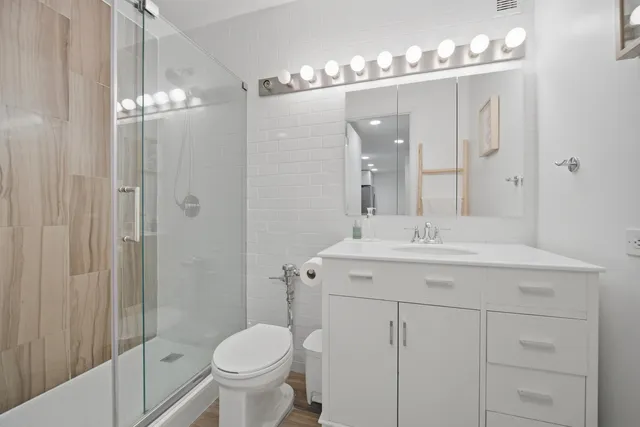 a bathroom with a sink toilet and shower