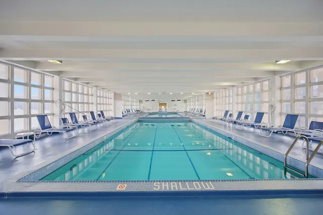 a room with lots of wooden floor and windows