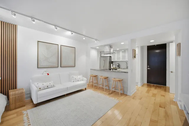 a spacious bedroom with a bed and a large mirror