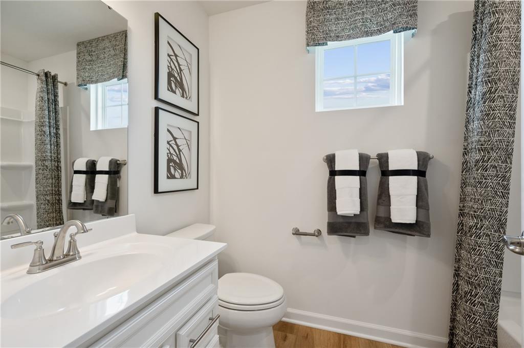 144 Crown Street McKees Rocks, PA 15136 - Photo 18 of 26 a bathroom with a toilet a sink and mirror