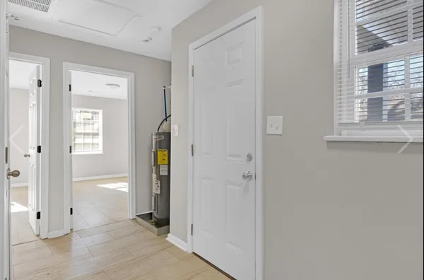 a view of hallway with wooden floor and closet