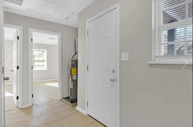 a view of hallway with wooden floor and closet