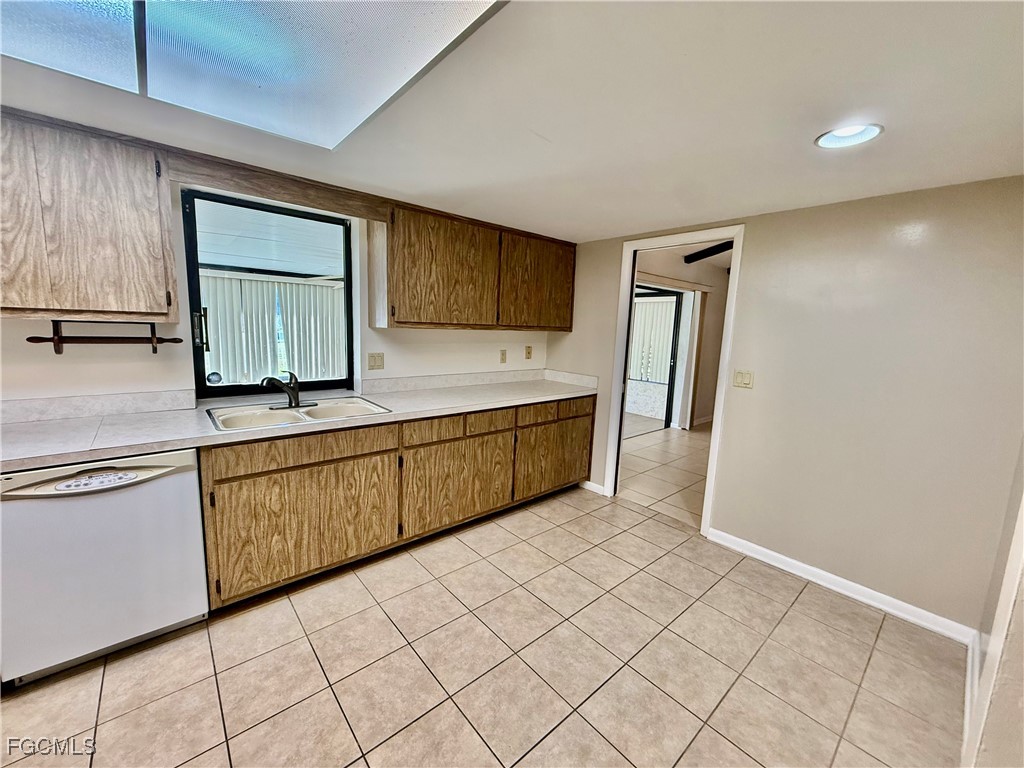 24 Clayton Avenue Lehigh Acres, FL 33936 - Photo 14 of 28 a kitchen with stainless steel appliances granite countertop a refrigerator and a sink