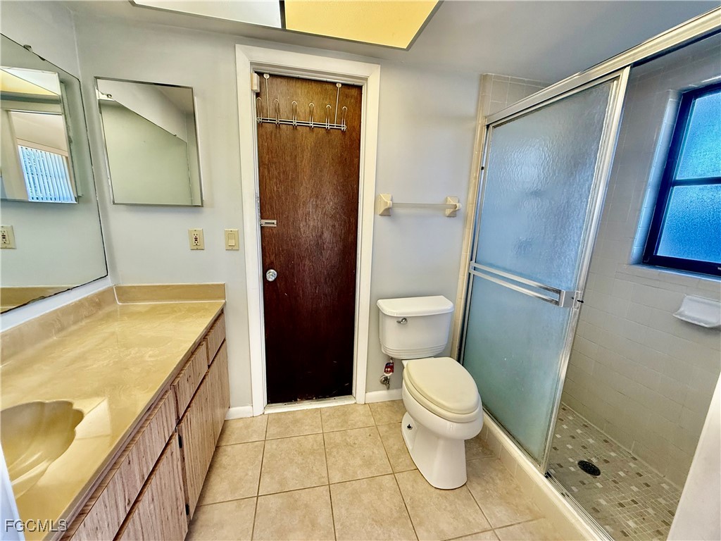 24 Clayton Avenue Lehigh Acres, FL 33936 - Photo 19 of 28 a bathroom with a granite countertop sink toilet and shower