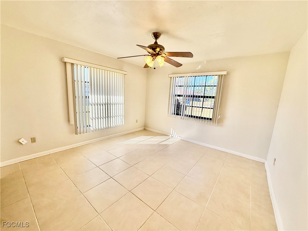 24 Clayton Avenue Lehigh Acres, FL 33936 - Photo 20 of 28 a view of a livingroom with a ceiling fan and window