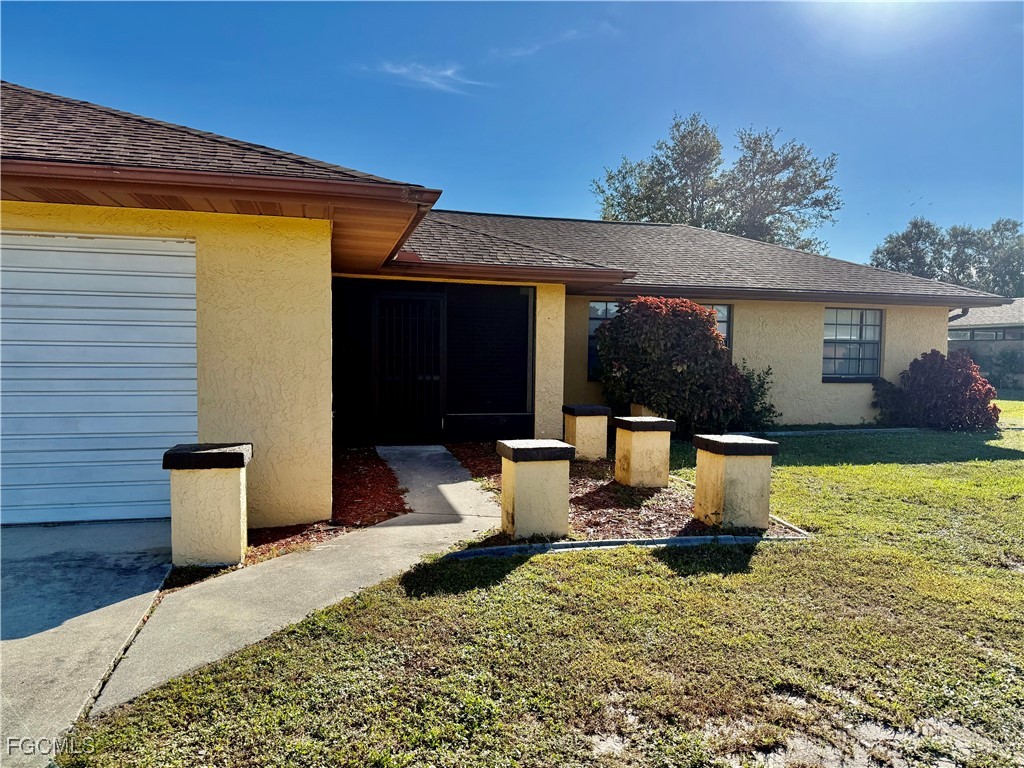 24 Clayton Avenue Lehigh Acres, FL 33936 - Photo 2 of 28 a view of a patio with couches chairs potted plants and sky view