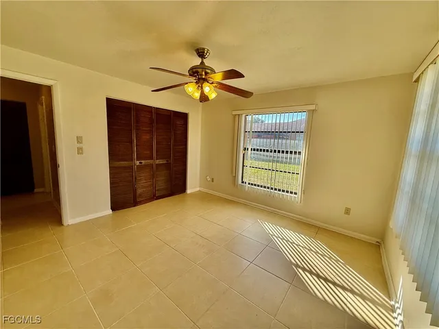 a bathroom with a granite countertop sink a toilet and mirror
