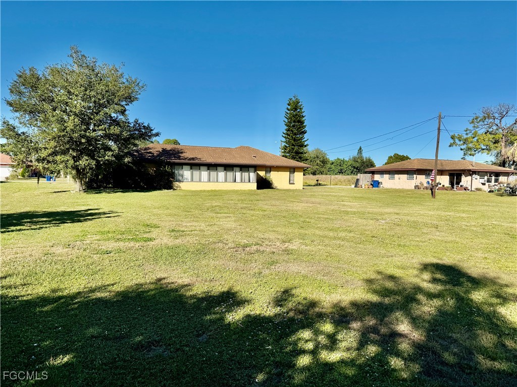 24 Clayton Avenue Lehigh Acres, FL 33936 - Photo 26 of 28 a view of a swimming pool with an outdoor seating