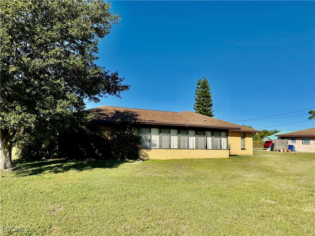24 Clayton Avenue Lehigh Acres, FL 33936 - Photo 28 of 28 a front view of a house with a yard
