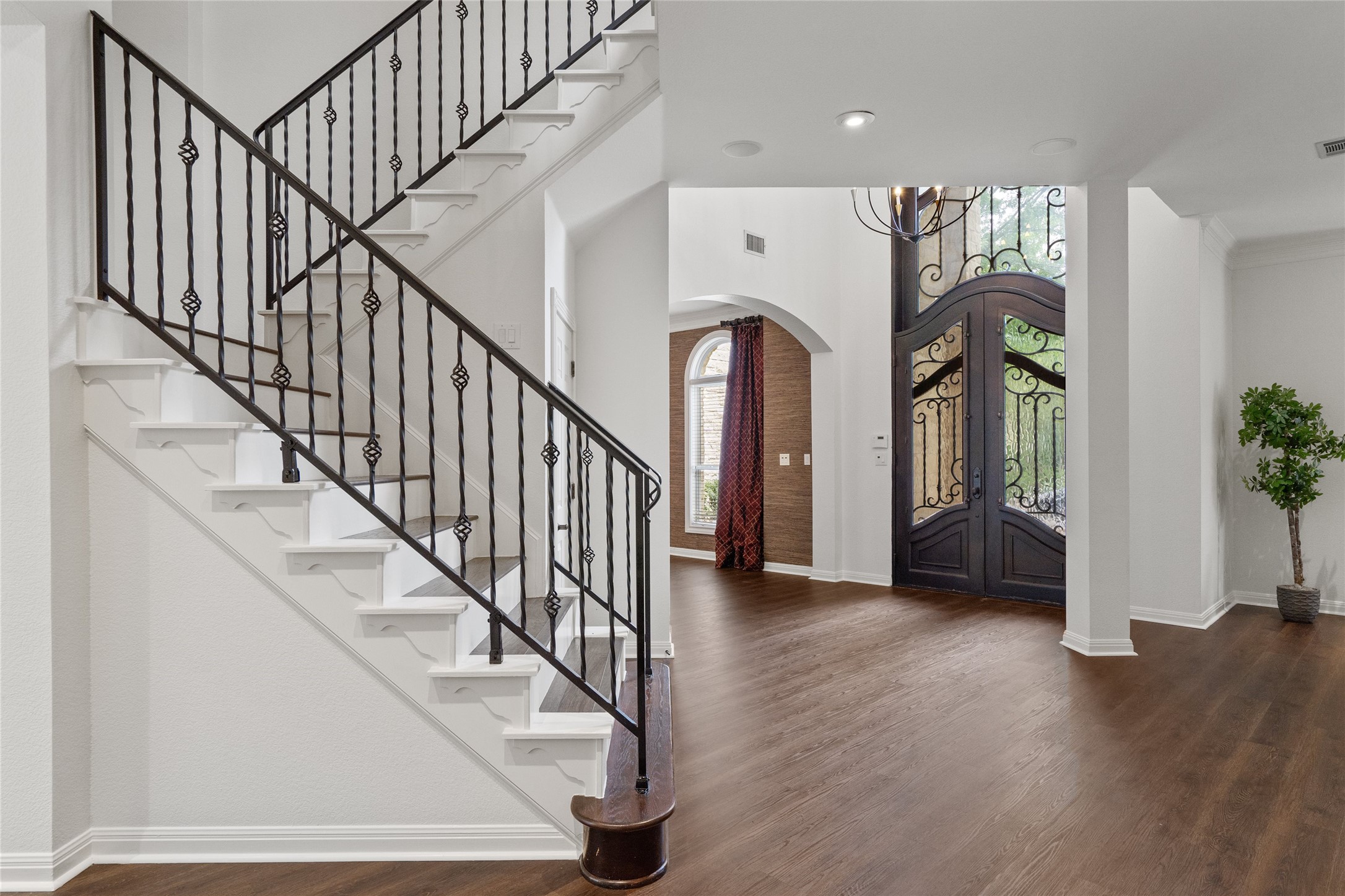 4313 Rio Robles Drive Austin, TX 78746 - Photo 4 of 40 Grand wrought iron staircase and rich wood flooring welcome you to this elegant home.
