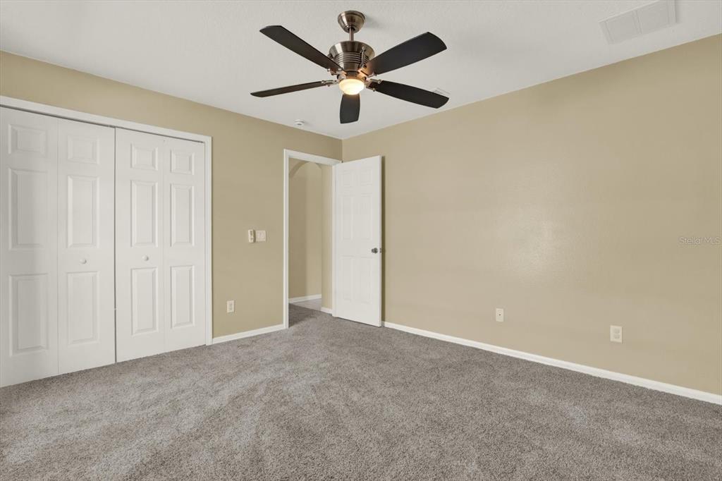 4400 Dior Road Spring Hill, FL 34609 - Photo 29 of 37 an empty room with closet and a chandelier fan