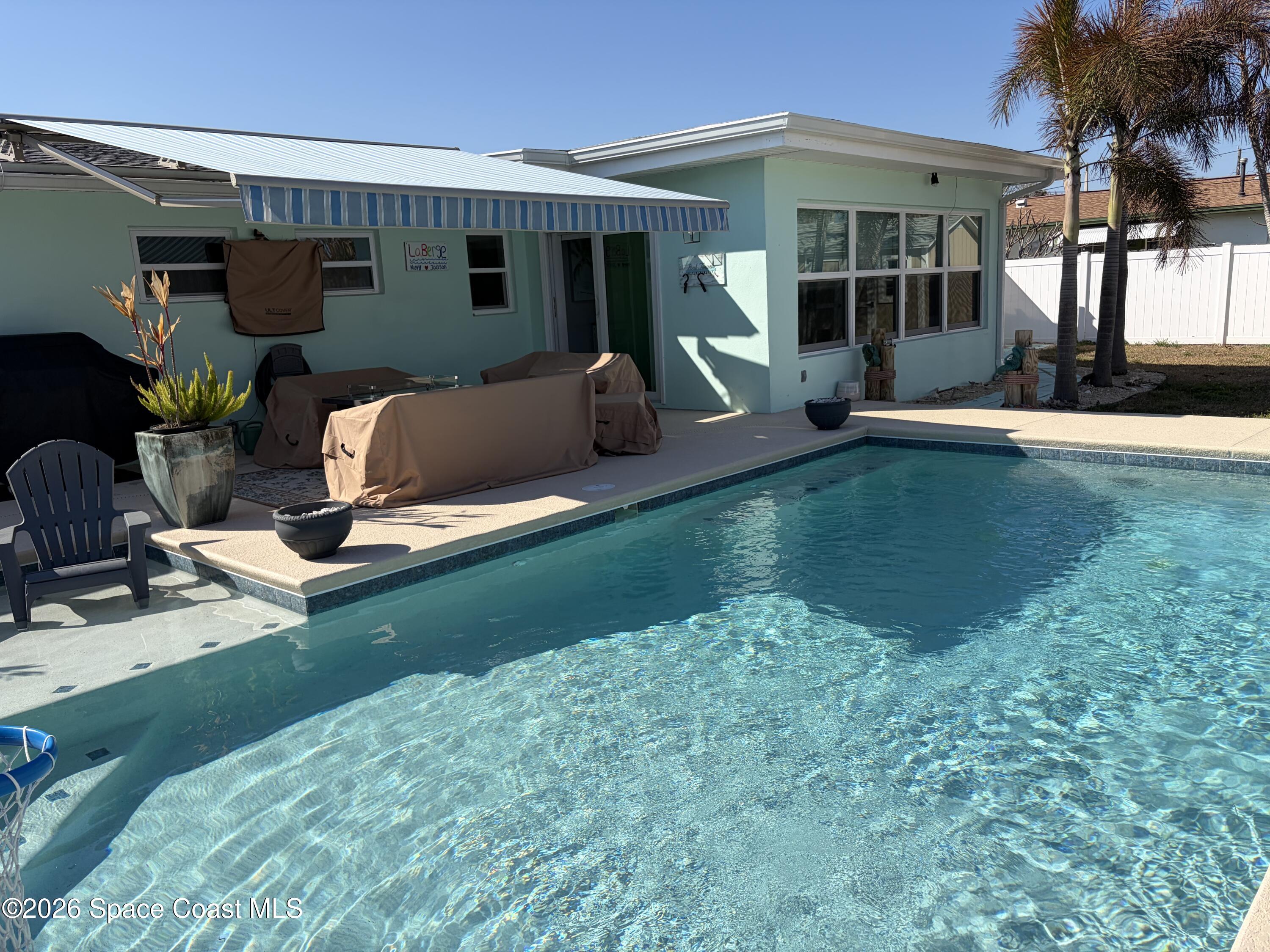 209 Southeast 3rd Street Satellite Beach, FL 32937 - Photo 16 of 25 a view of a house with backyard sitting area and swimming pool