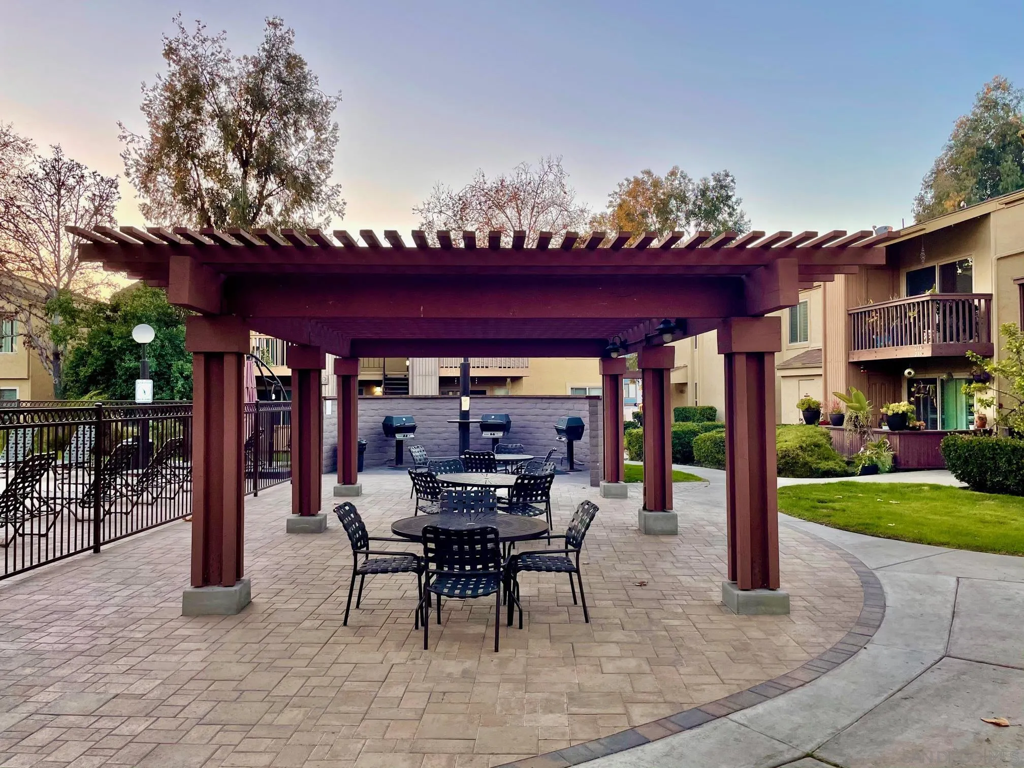 5970 Rancho Mission Road, Unit 244 San Diego, CA 92108 - Photo 19 of 21 a view of a patio with a table and chairs