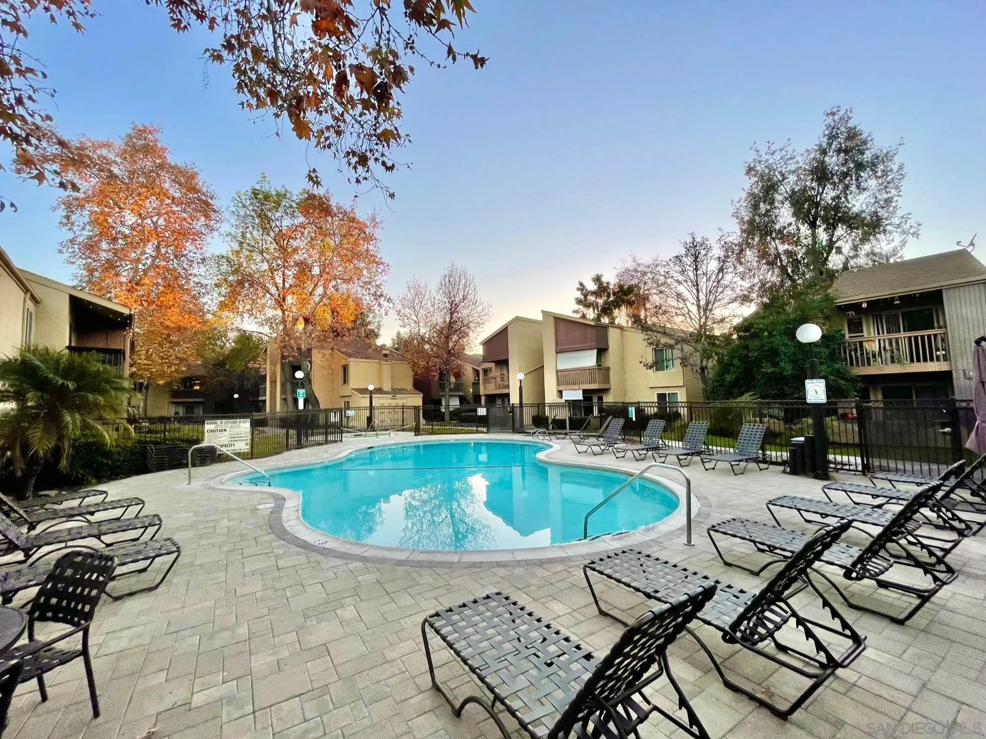 5970 Rancho Mission Road, Unit 244 San Diego, CA 92108 - Photo 20 of 21 a swimming pool with outdoor seating and yard