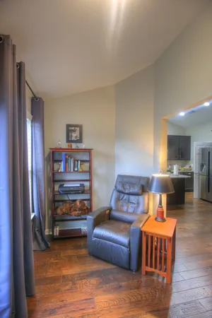 a living room with furniture and a wooden floor