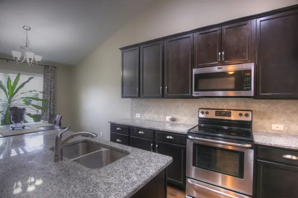 a kitchen with a sink stove and cabinets