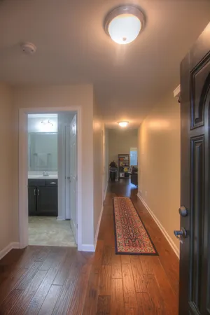 a view of a hallway view with wooden floor and staircase
