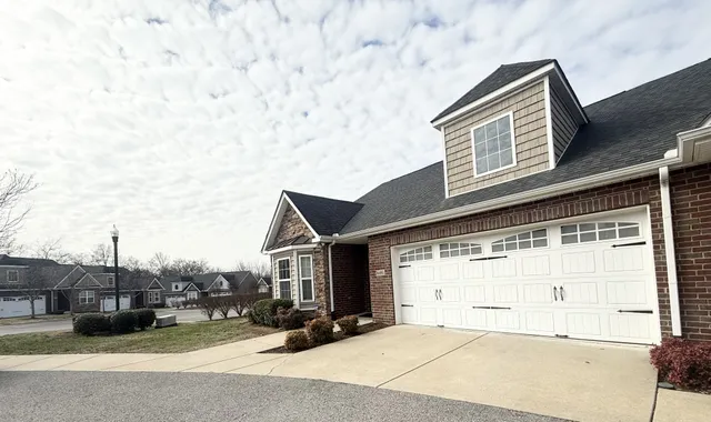 a backyard of a house with garage and parking space