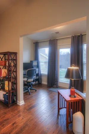 a dining room with furniture and wooden floor