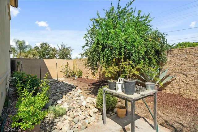 a backyard of a house with table and chairs
