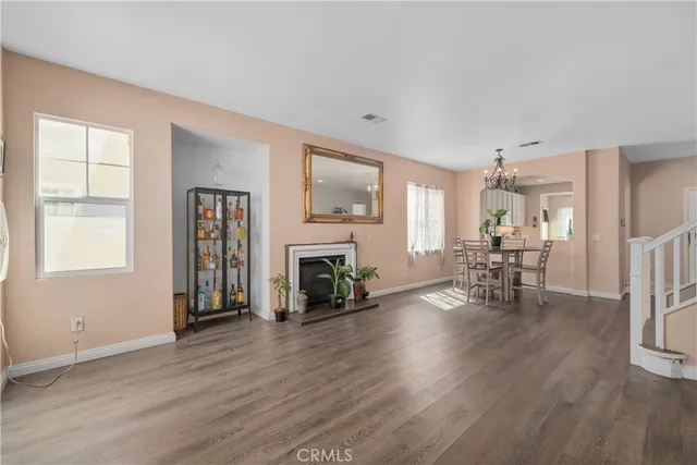 a living room with fireplace furniture and a wooden floor