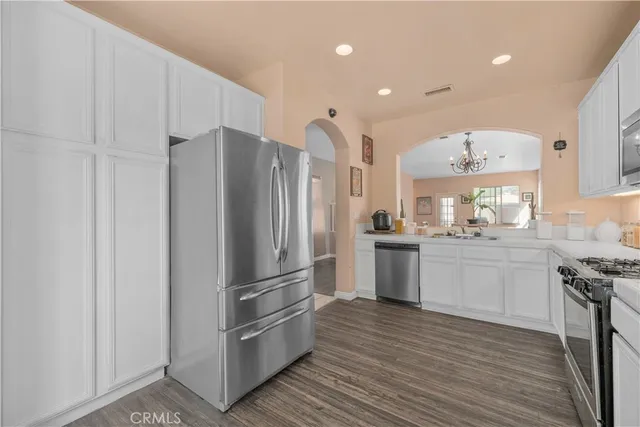 a kitchen with a refrigerator sink and cabinets