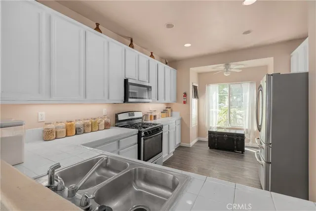 a kitchen filled with stainless steel appliances granite countertop a refrigerator sink and stove