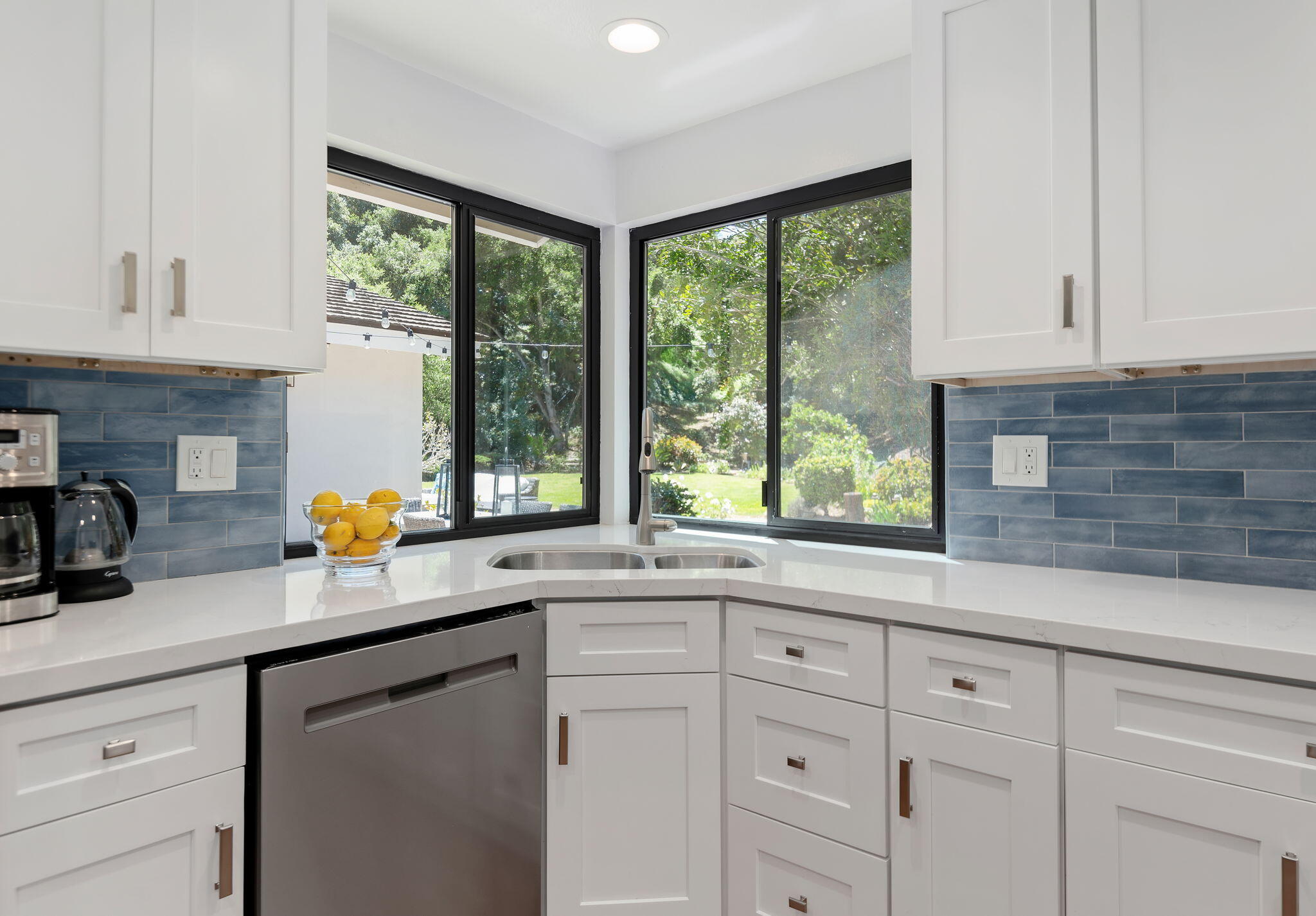 1102 Plaza Del Monte Santa Barbara, CA 93101 - Photo 14 of 53 a kitchen with stainless steel appliances white cabinets a window and a sink