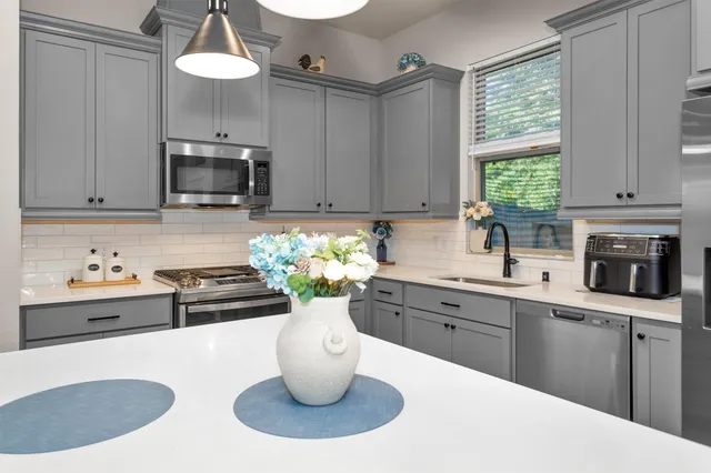 a kitchen with stainless steel appliances a stove sink and cabinets
