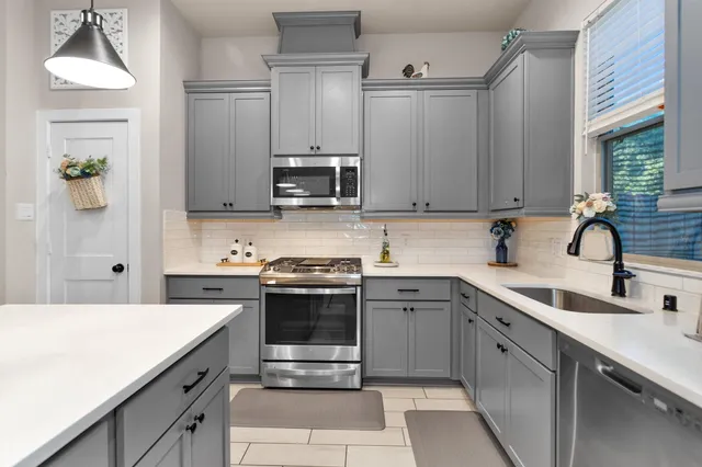 a kitchen with a sink stove and refrigerator