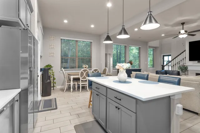 a large kitchen with a table and chairs in it