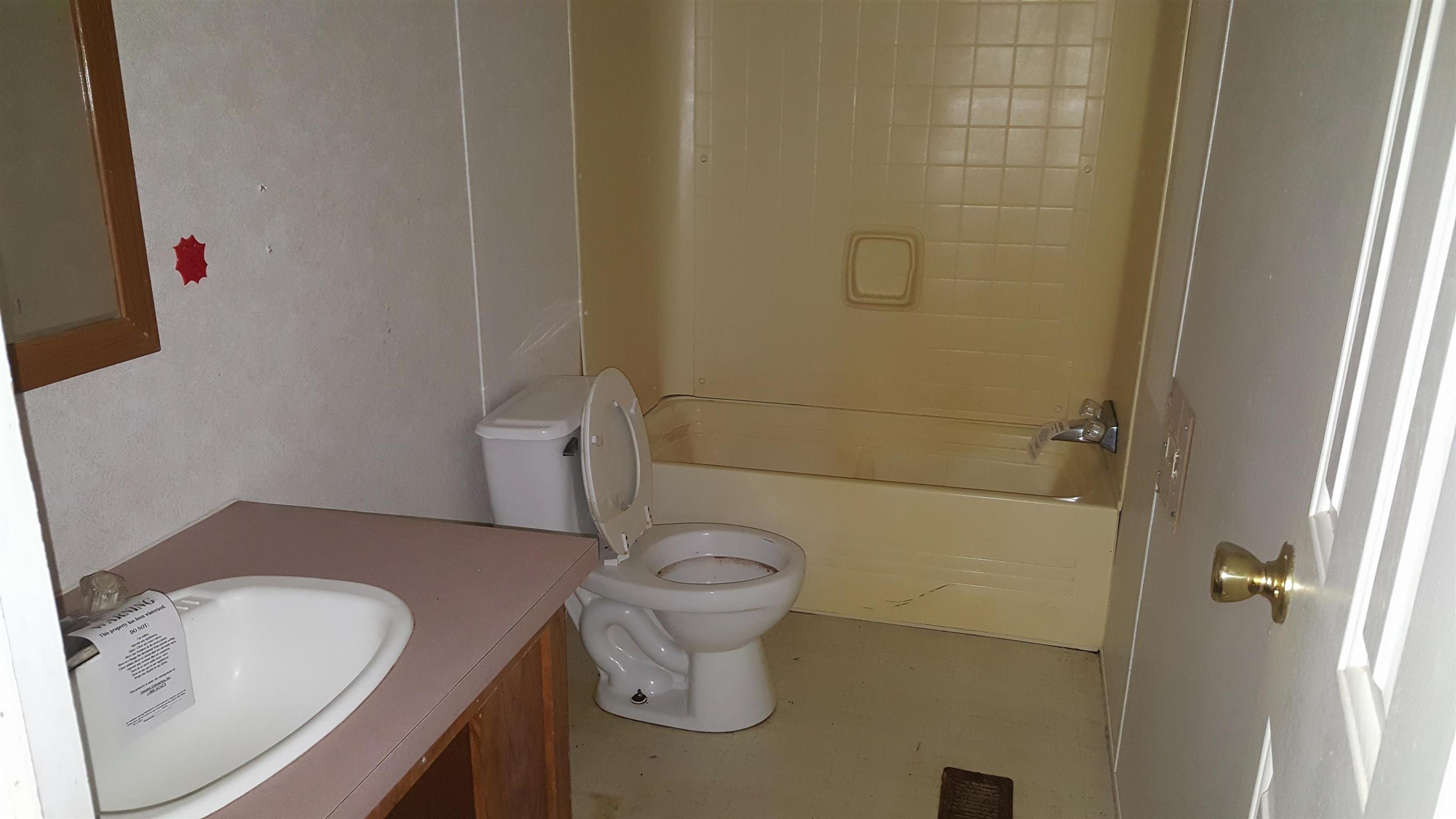 10 Zinker Road Lawrenceburg, TN 38464 - Photo 6 of 11 a bathroom with a granite countertop toilet and a sink