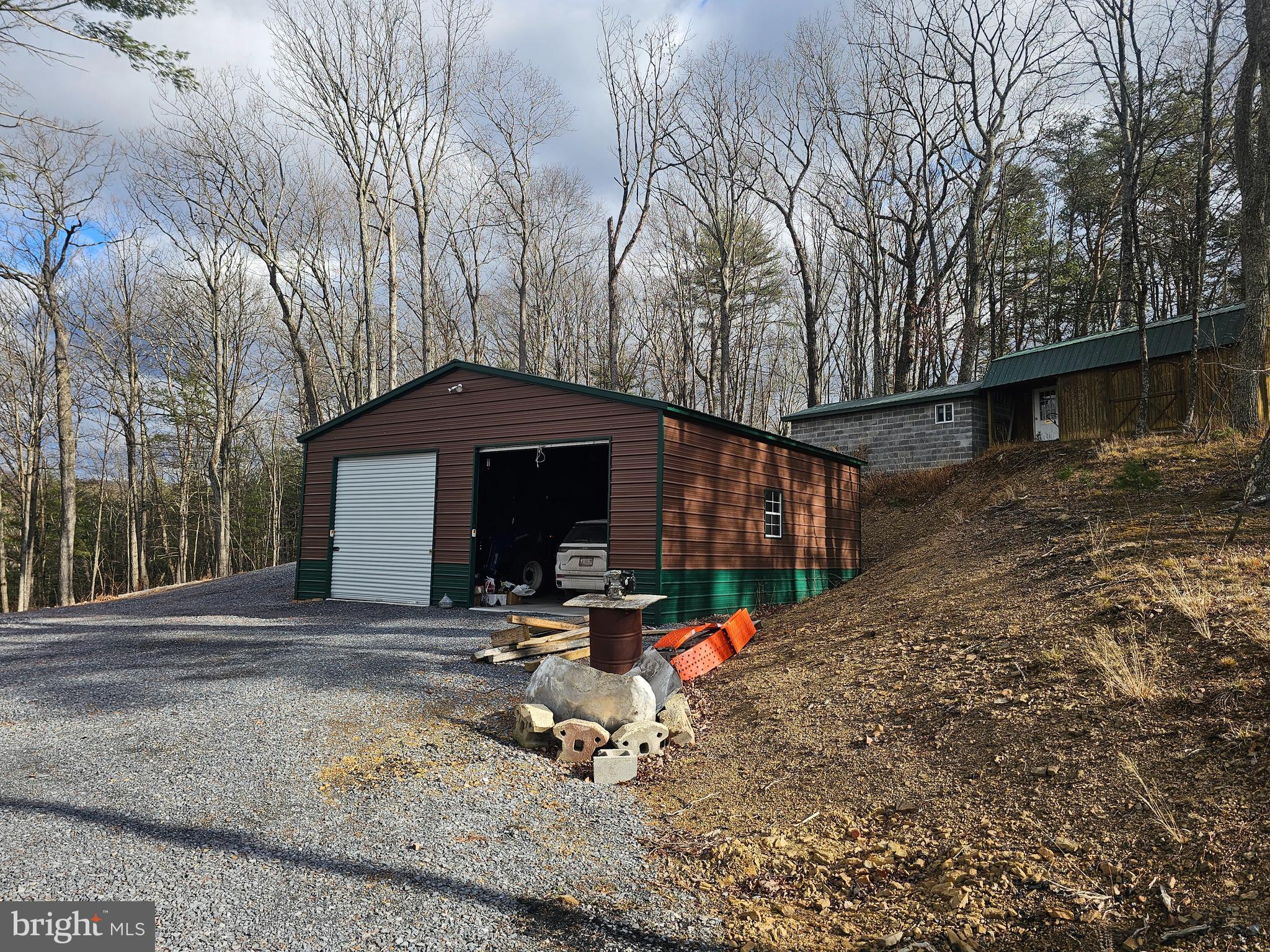 211 Martin Road Artemas, PA 17211 - Photo 24 of 38 a backyard of a house with table and chairs under an umbrella