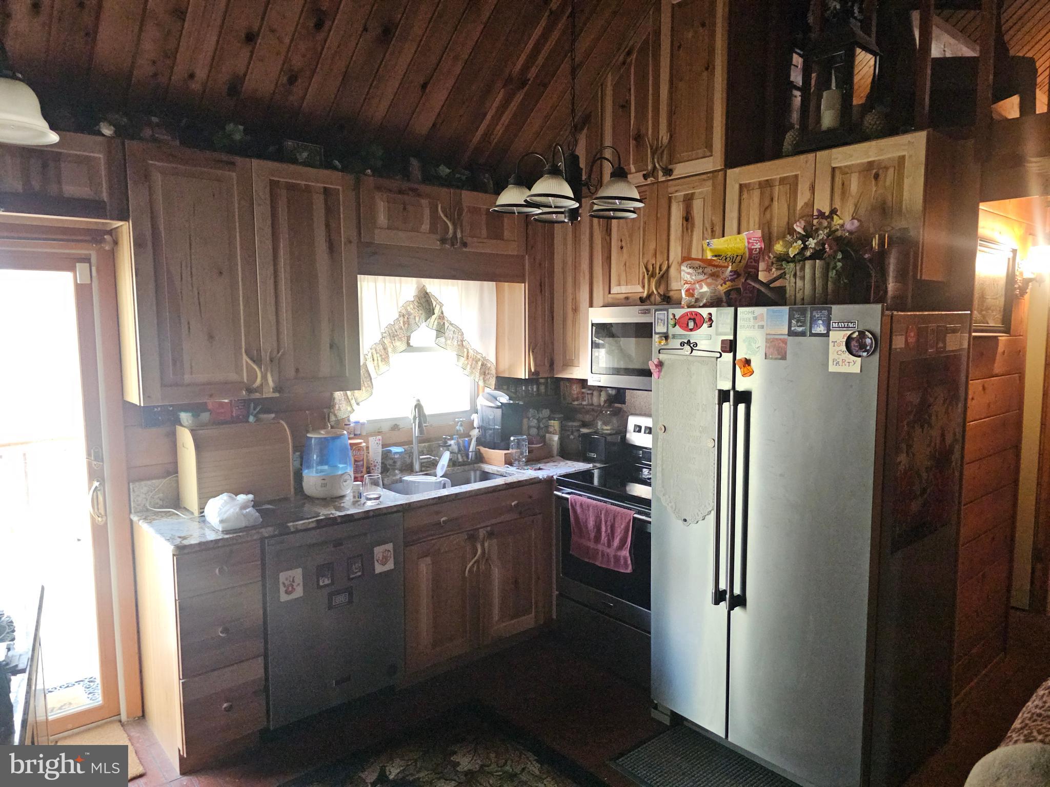 211 Martin Road Artemas, PA 17211 - Photo 28 of 38 a kitchen with stainless steel appliances granite countertop a refrigerator and a sink